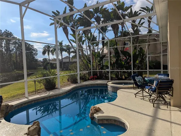 a view of a swimming pool with a patio and couches
