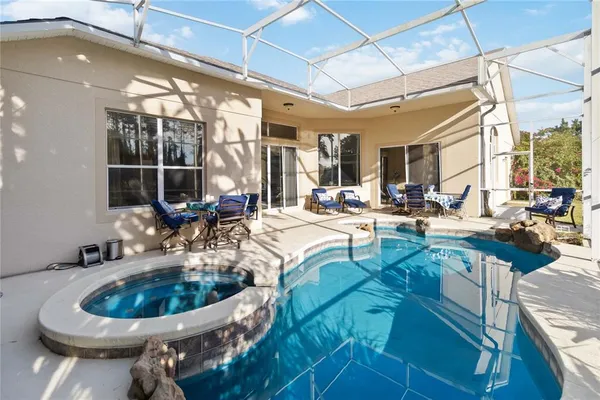 a kitchen with a sink a stove and a view of living room