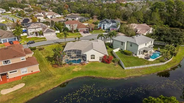 an aerial view of a house with a swimming pool outdoor seating and yard