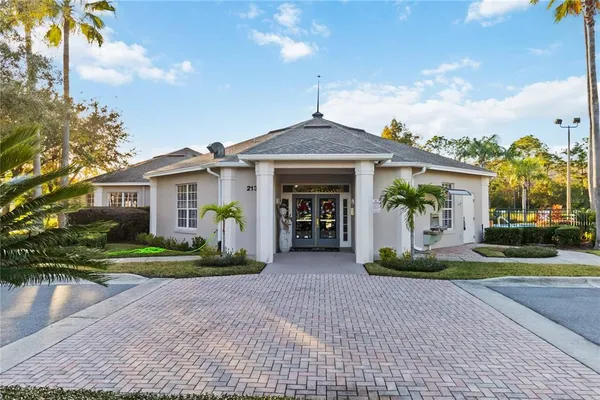 a front view of a house with a yard and potted plants