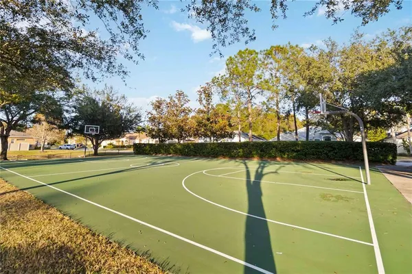 a view of tennis court with trees