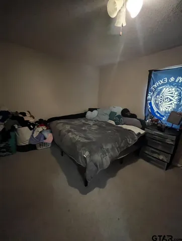 a bed sitting in a room next to a window