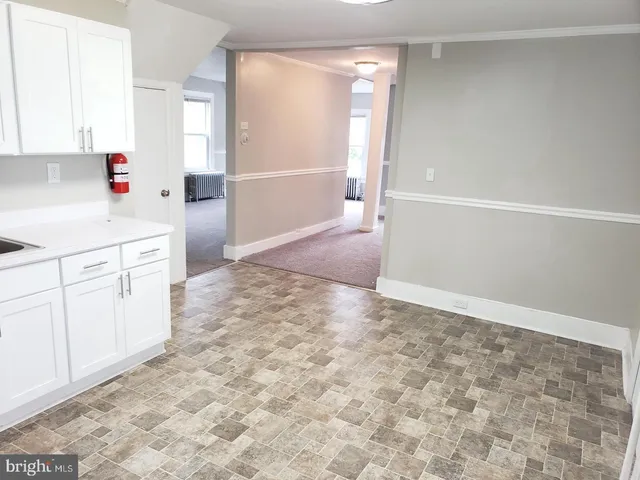 a view of kitchen with white cabinets