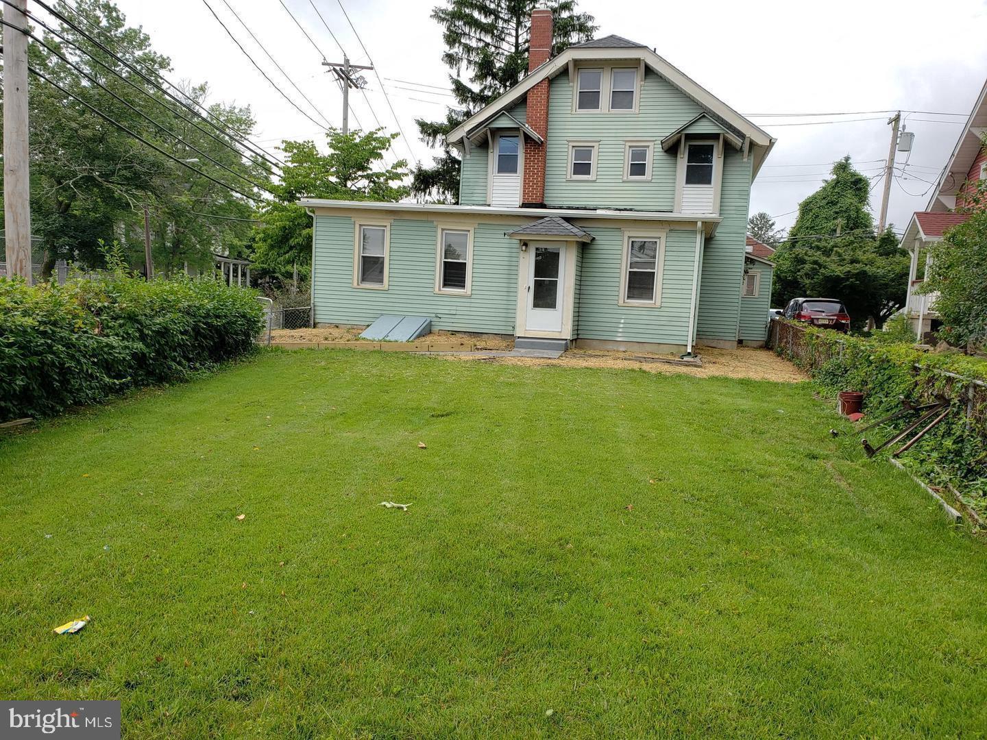 3 North Summit Avenue, Unit 3A Pitman, NJ 08071 - Photo 3 of 22 a white house sitting in middle of the grass