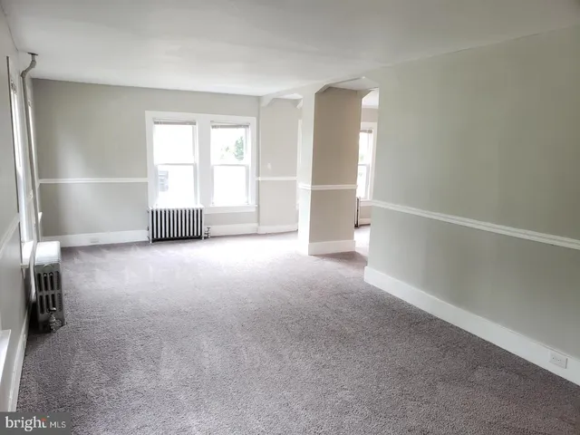 a view of empty room with a fireplace