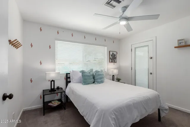 a kitchen with stainless steel appliances granite countertop a stove top oven a sink dishwasher a refrigerator and a dining table with wooden floor