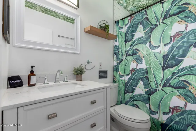 a bedroom with a bed and a mirror