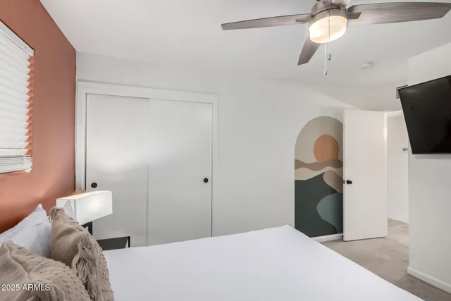 a bedroom with a bed and chair