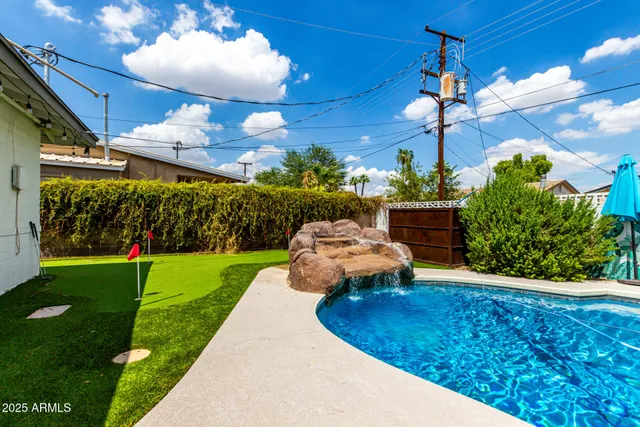 a view of a chairs and tables in the backyard
