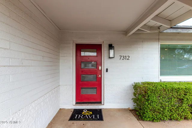 a view of a dining room with furniture and a chandelier