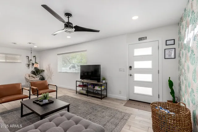 a living room with furniture and a ceiling fan