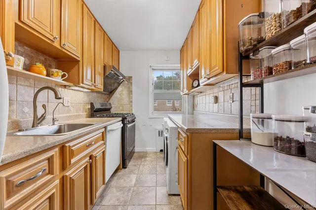 a kitchen with a sink and a stove top oven