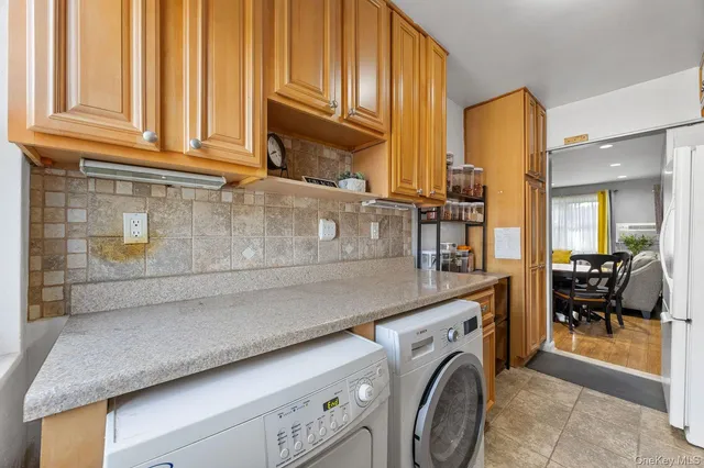a utility room with multiple dryer and washer