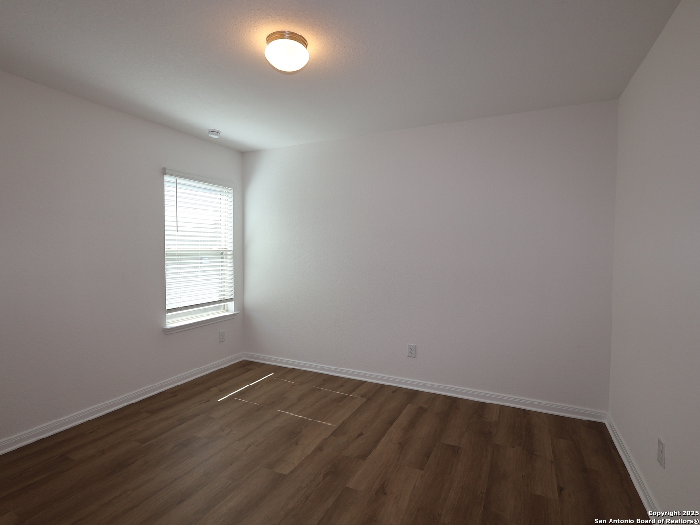 2804 Whiskey Pass Seguin, TX 78155 - Photo 14 of 28 an empty room with wooden floor and windows