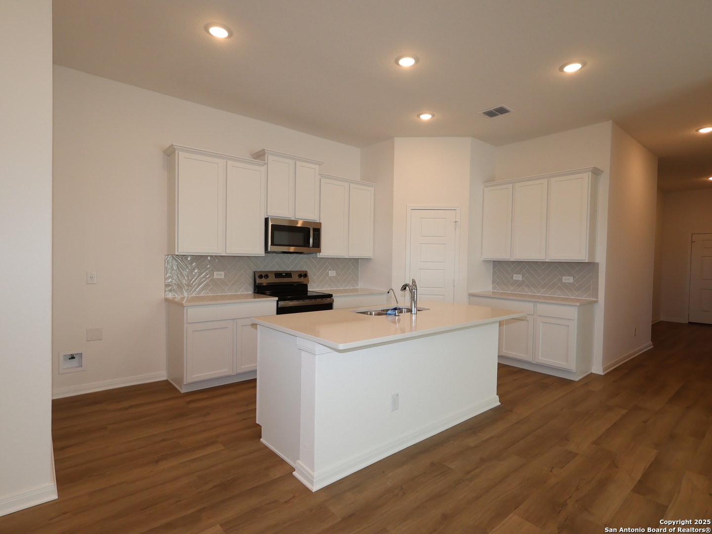2804 Whiskey Pass Seguin, TX 78155 - Photo 3 of 28 a kitchen with white cabinets stainless steel appliances and sink