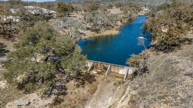 an aerial view of house with yard and mountain view in back