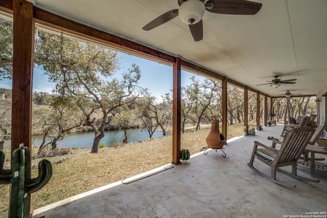 a front view of a house with a yard and fountain