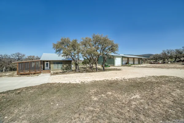 a view of a livingroom with furniture and floor to ceiling window
