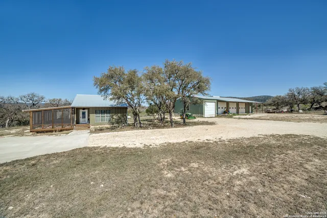 a view of a livingroom with furniture and floor to ceiling window