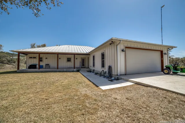 a view of a dry yard with trees