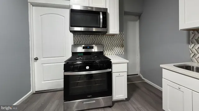 a kitchen with a stove and a microwave