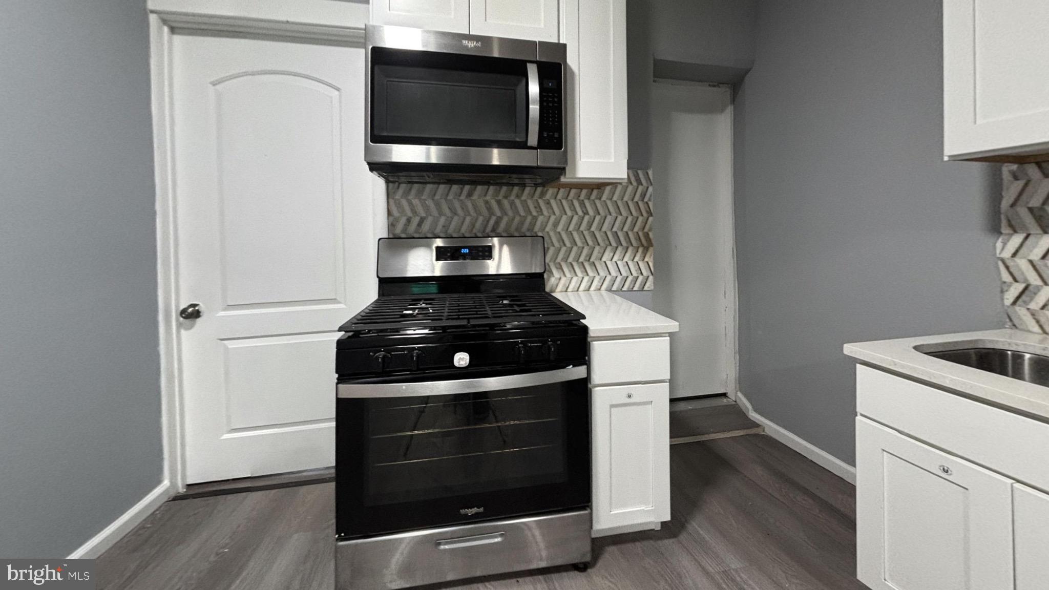 a kitchen with a stove and a microwave