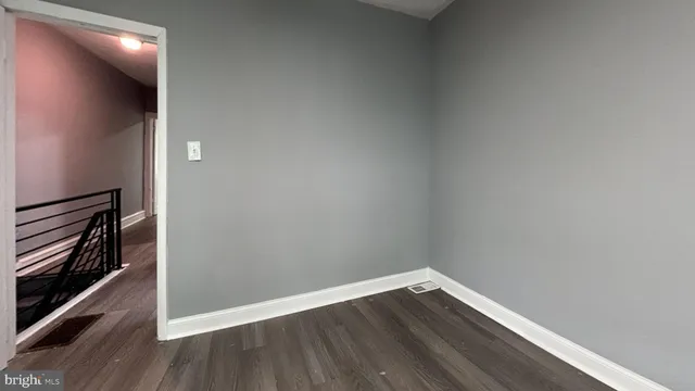 a view of an empty room and wooden floor