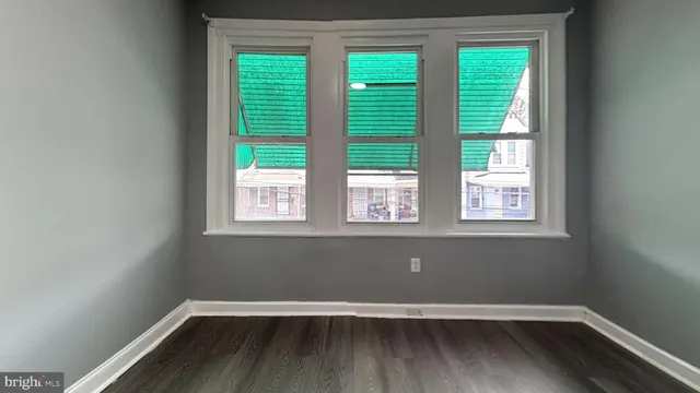 a view of wooden floor and window in a room