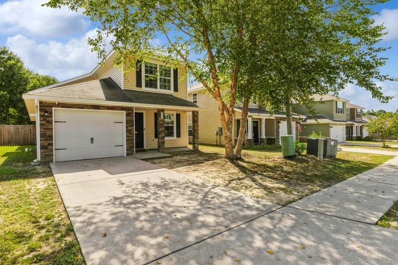 a front view of a house with garden