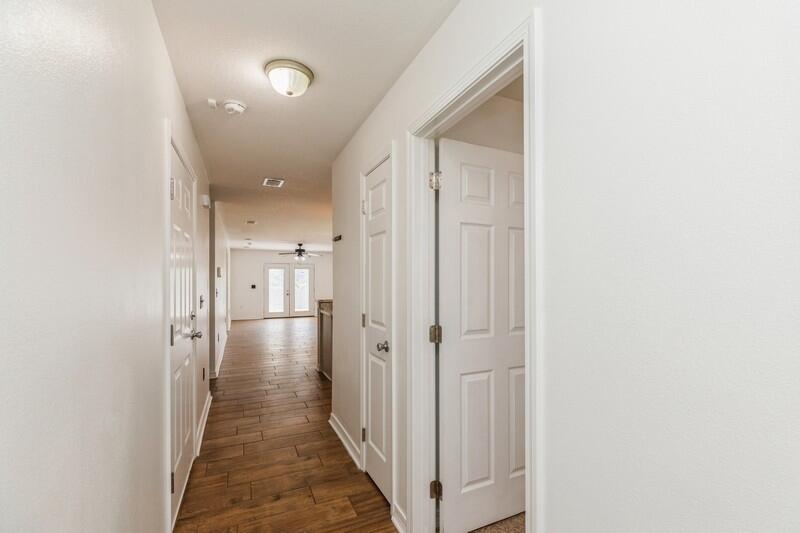 412 Eisenhower Drive Crestview, FL 32539 - Photo 15 of 35 a view of a hallway with a closet and wooden floor