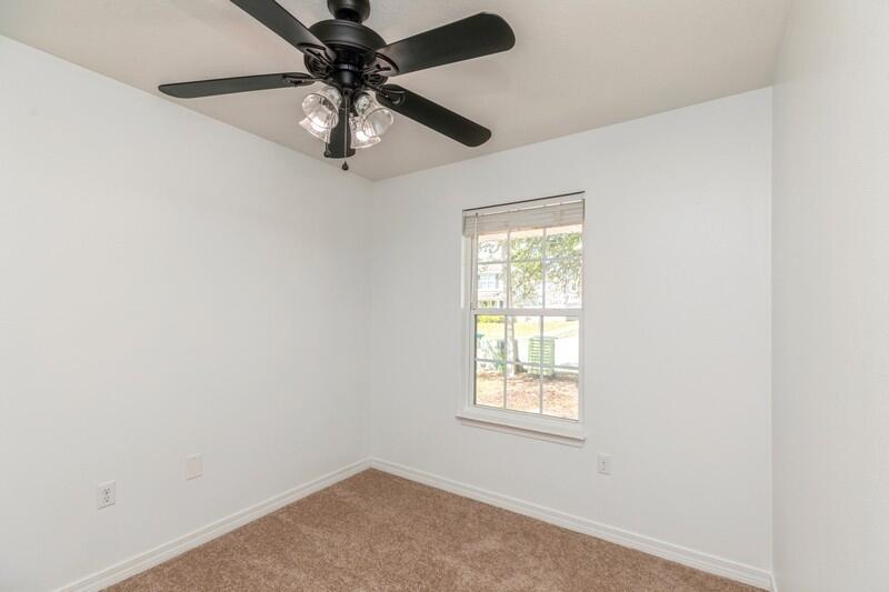 412 Eisenhower Drive Crestview, FL 32539 - Photo 16 of 35 an empty room with a window and a fan