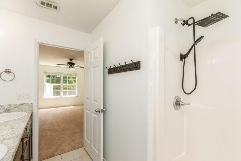 412 Eisenhower Drive Crestview, FL 32539 - Photo 22 of 35 a bathroom with a granite countertop shower a sink and a window
