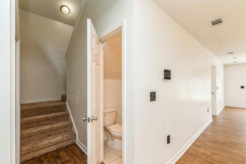 412 Eisenhower Drive Crestview, FL 32539 - Photo 23 of 35 a view of a hallway with wooden floor and staircase