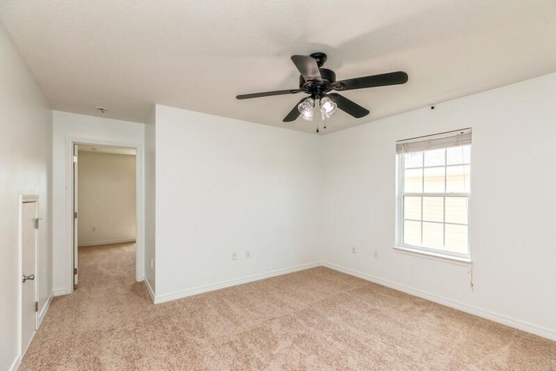 412 Eisenhower Drive Crestview, FL 32539 - Photo 25 of 35 an empty room with a ceiling fan and a window