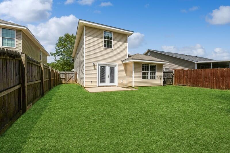 412 Eisenhower Drive Crestview, FL 32539 - Photo 34 of 35 a front view of a house with a garden