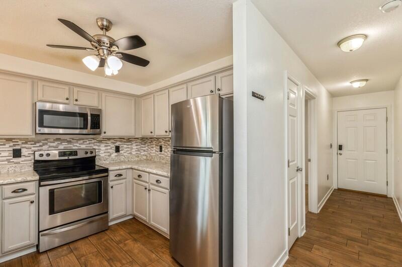 412 Eisenhower Drive Crestview, FL 32539 - Photo 5 of 35 a kitchen with stainless steel appliances white cabinets and a refrigerator