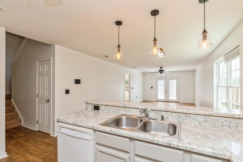 412 Eisenhower Drive Crestview, FL 32539 - Photo 8 of 35 a kitchen with sink cabinets and window