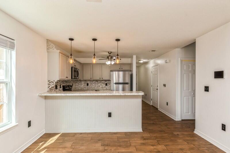 412 Eisenhower Drive Crestview, FL 32539 - Photo 9 of 35 a view of a kitchen with kitchen island a sink a stove and a window