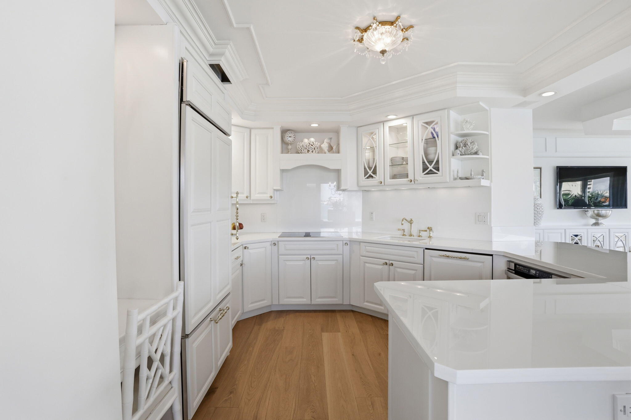701 East Camino Real, Unit 2J Boca Raton, FL 33432 - Photo 13 of 51 a kitchen with kitchen island white cabinets and sink