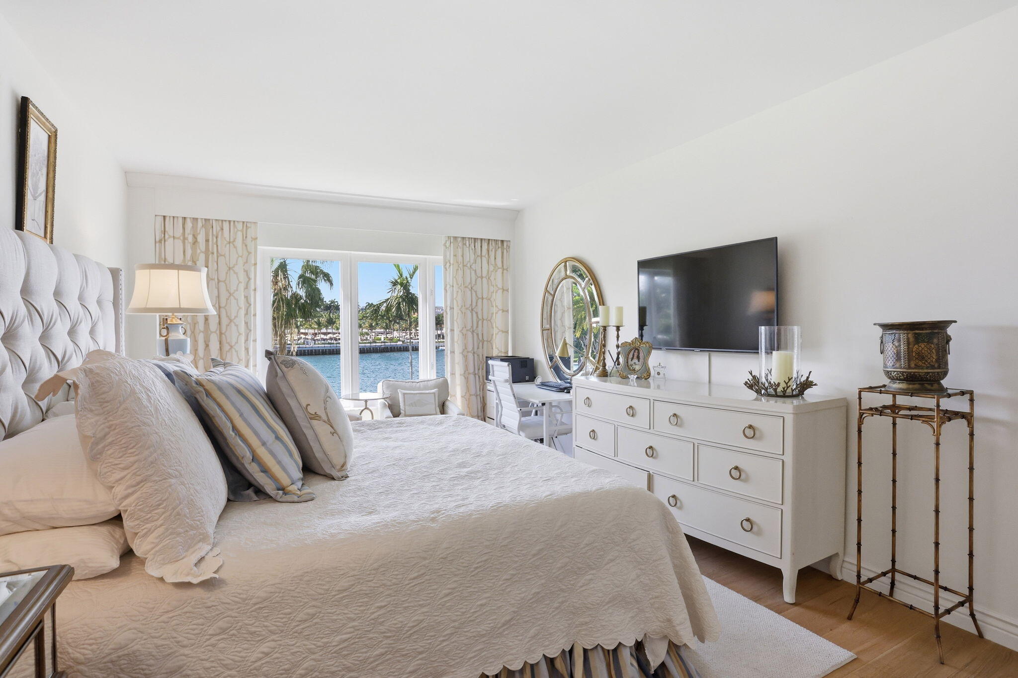 701 East Camino Real, Unit 2J Boca Raton, FL 33432 - Photo 19 of 51 a bedroom with a bed and a flat screen tv