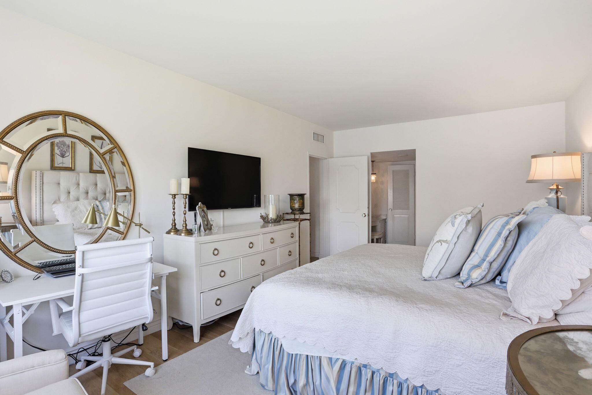 701 East Camino Real, Unit 2J Boca Raton, FL 33432 - Photo 21 of 51 a bedroom with a bed and a flat screen tv