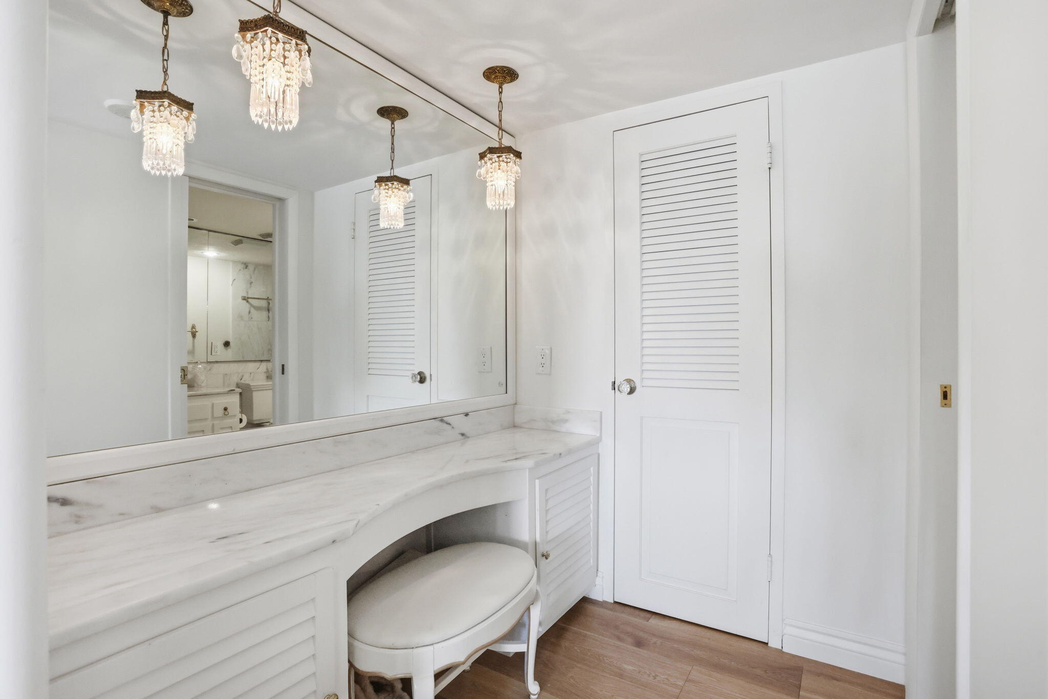 701 East Camino Real, Unit 2J Boca Raton, FL 33432 - Photo 22 of 51 a bathroom with a toilet a sink and mirror