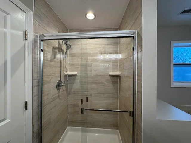 a bathroom with a glass shower door