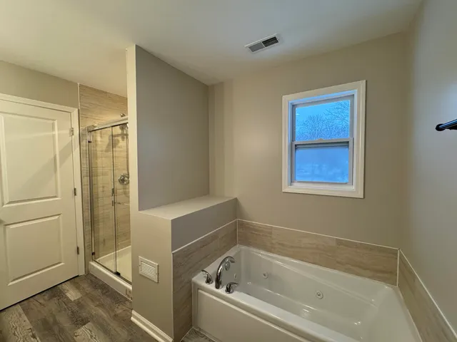 a bathroom with a bathtub and shower