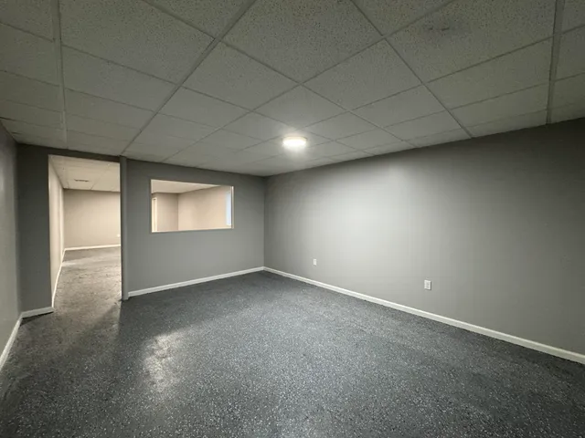 an empty room with a empty space and windows