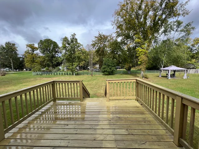 a view of balcony with wooden floor and fence