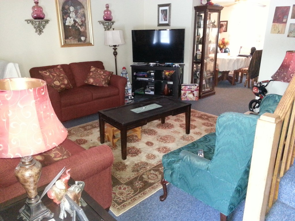1 Manor Court, Unit 1 Springfield, MA 01118 - Photo 3 of 19 a living room with furniture and a flat screen tv