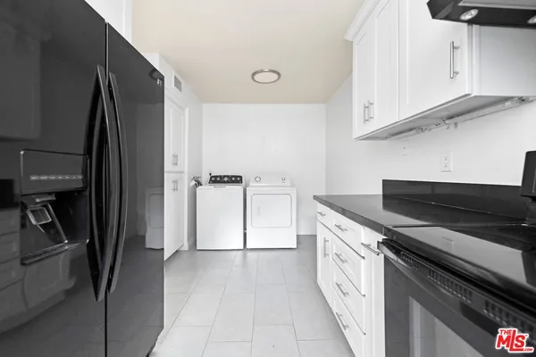a kitchen with a sink and a refrigerator