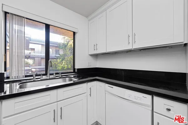 a kitchen with a sink and a large window