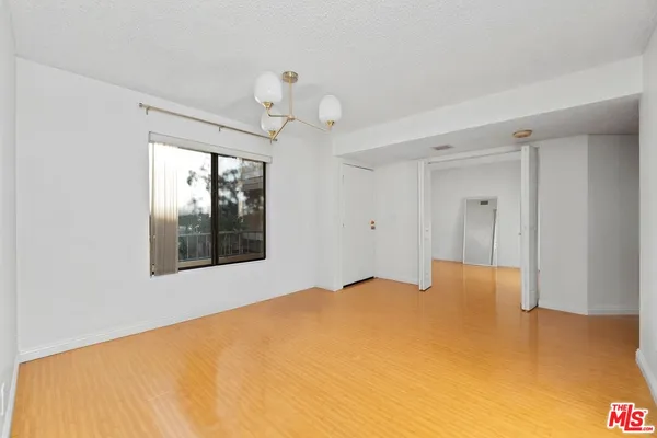 a view of a big room with windows and cabinet